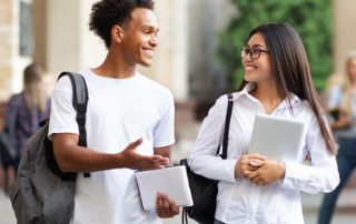 An image of two students chatting and walking to class.