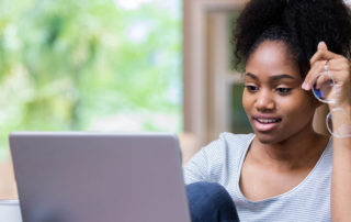 A young woman working on her laptop.