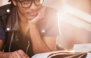 An image of a young man reading course materials.