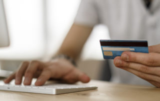 An image of a student entering credit card information on their desktop computer.