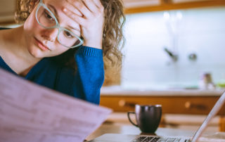 An image of a student working on a budget.